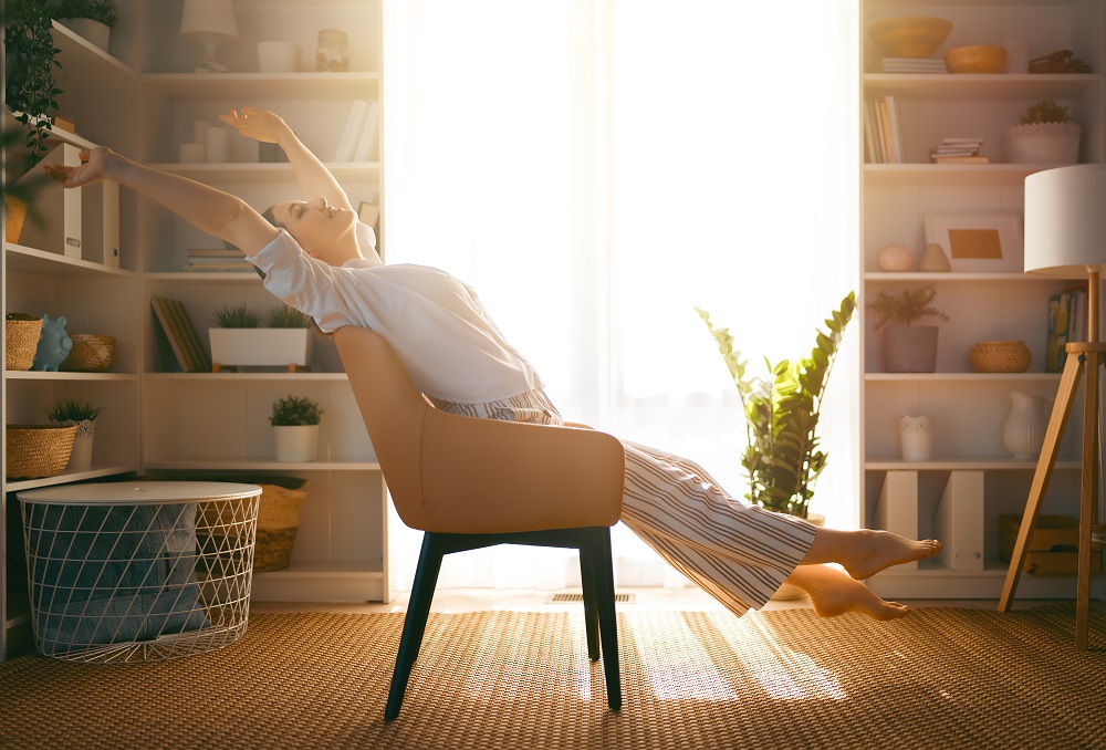 Portrait of beautiful woman resting on armchair at home.